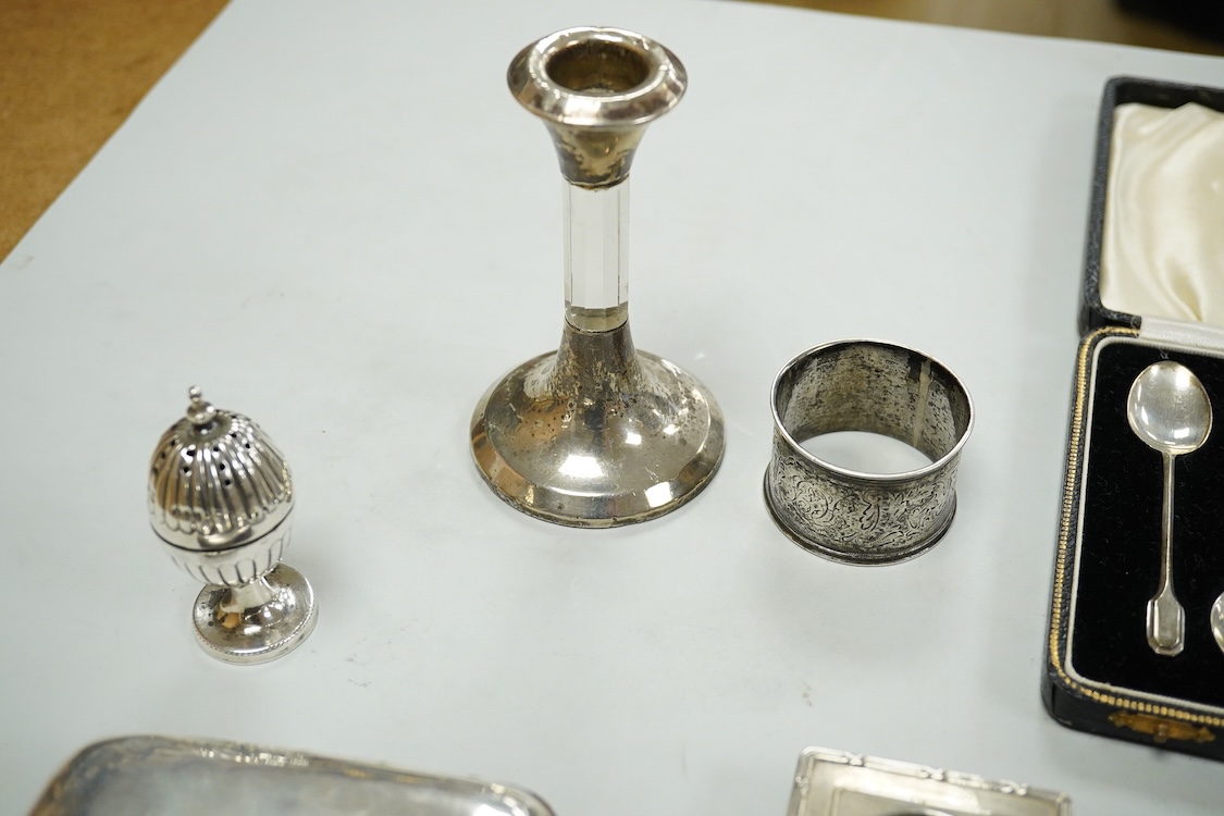 A collection of assorted small silver, including set of six 1930's coffee spoons, a mounted travelling pocket watch case, Victorian pepperette, mounted glass dwarf candlestick, enamelled powder box, Georgian stilton scoo